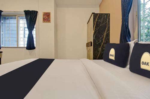 a bedroom with a bed and a window at Super Collection O Grey House in Pune