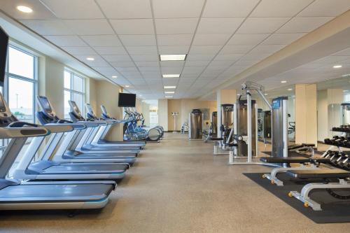 a gym with rows of treadmills and machines at Houston Marriott Sugar Land in Sugar Land