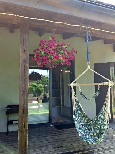 a hammock hanging on the front porch of a house at OSADA POD LASEM in Andrychów