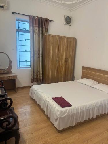 a bedroom with a bed and a desk and a window at Thanh Lịch Homestay in Hanoi