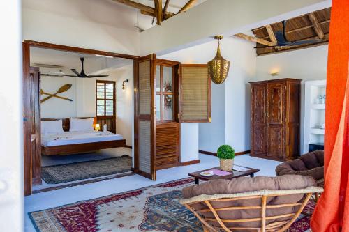 a bedroom with a bed and a living room at ZAN Sun Beach in Makunduchi