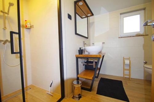 a bathroom with a sink and a toilet at Holiday house Zara, Pomer in Pomer