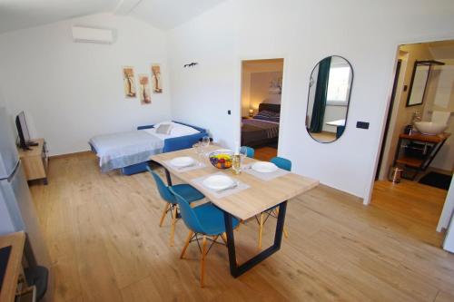 a room with a table and chairs and a bedroom at Holiday house Zara, Pomer in Pomer