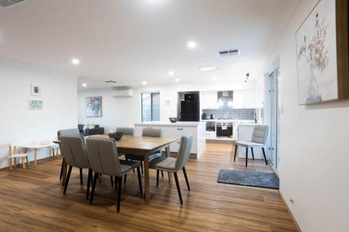 a dining room and kitchen with a table and chairs at Family Retreat in Perth