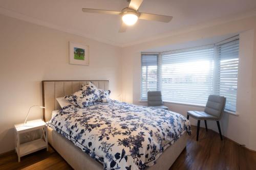 a bedroom with a bed and a ceiling fan at Family Retreat in Perth