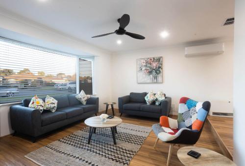 a living room with two couches and a table at Family Retreat in Perth