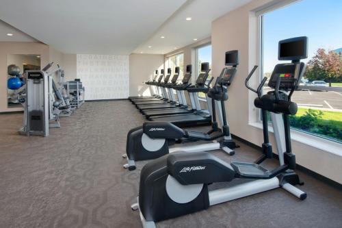 a row of tread machines in a gym with a window at SpringHill Suites by Marriott Indianapolis Keystone in Indianapolis