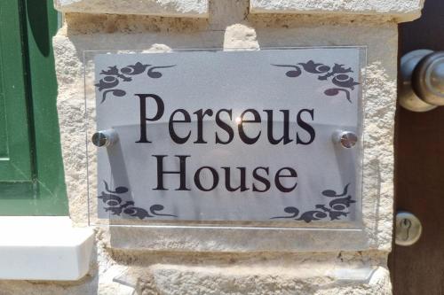 a sign for a house on the side of a building at Cyprus Townhouse Pool Patio Aircon Free Parking in Polis Chrysochous