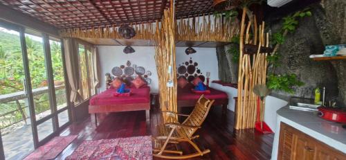 a room with two beds and a mirror at Mai Pen Rai Bungalows in Than Sadet Beach