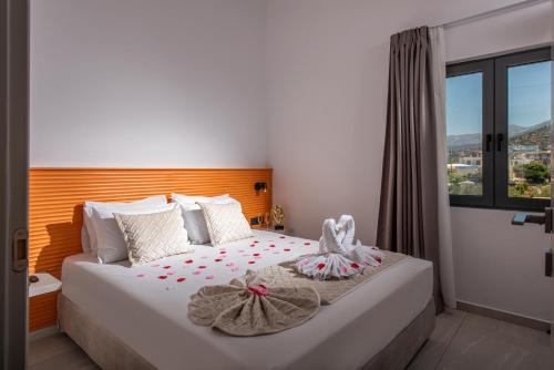 a bedroom with a bed with two towels on it at Meramaglia Hotel in Malia