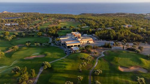 an aerial view of a house on a golf course at Korineum Golf & Beach Resort in Kérynia