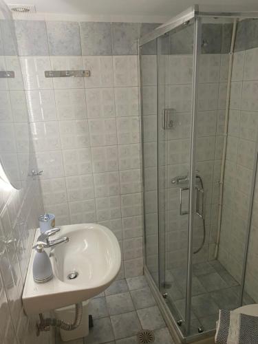 a bathroom with a sink and a shower at Two Palm Trees 1 in Adamantas