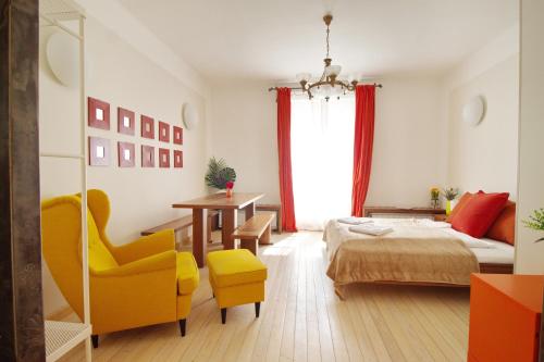 a bedroom with a bed and a table and a chair at Premium Buda Castle Apartment in Budapest