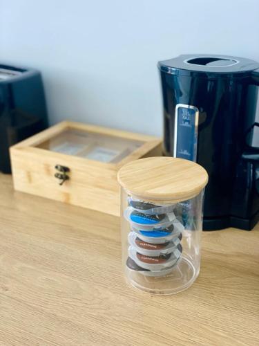 a plastic container filled with toothbrushes on a table at Le Petit Ponot, cosy dans l’hypercentre in Le Puy en Velay