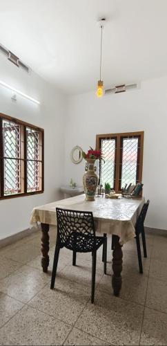 a table with a vase on it in a room at David Homes in Cochin