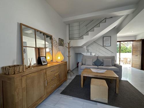 a living room with a couch and a table at MARINA 24 by SOM Menorca in Fornells