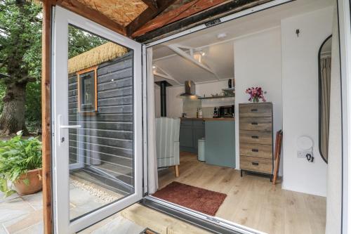 an exterior view of a tiny house with a sliding glass door at Charltons Hollow Cabin in Haywards Heath