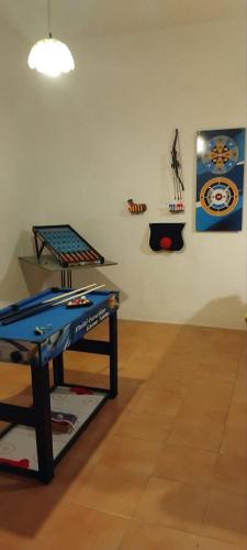 a room with a table with a surfboard on it at EMPHASIS Traditional House in Apodhoúlou