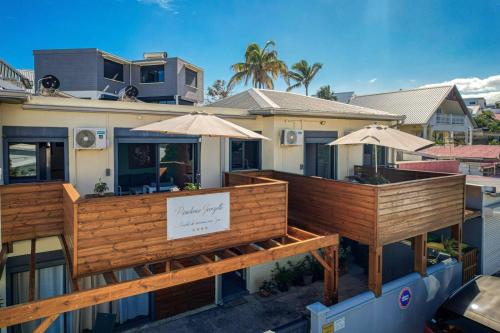 a building with two decks with umbrellas on it at T3 - 100m2 - Résidence Georgette in Terre Sainte