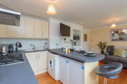 a kitchen and living room with a sink and a stove at Free Parking - City Centre - 3 Bedrooms - 5 Guests in Edinburgh