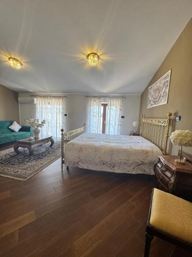 a bedroom with a large bed and a couch at B&B Anna in Marigliano