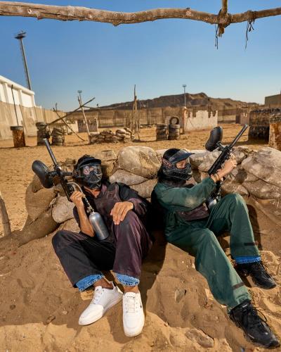 a group of three men laying on the ground with guns at Ramage Hotel & Resort in Cairo