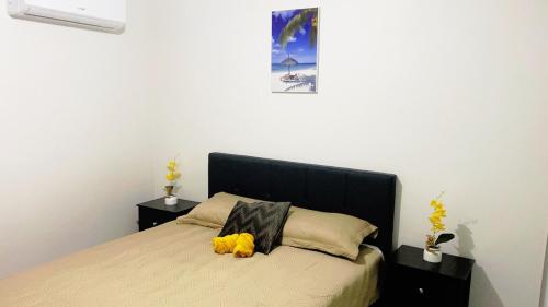 a bedroom with a bed with a stuffed animal on it at Casita Velera in Lajas