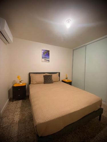 a bedroom with a bed and two night stands at Casita Velera in Lajas