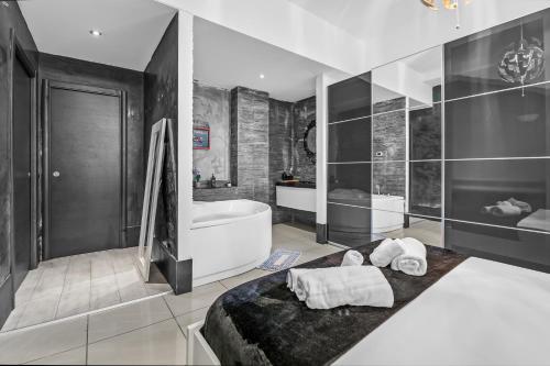 a bathroom with a tub and a sink and a bath tub at Luxury House Jacuzzi - Milano in Milan