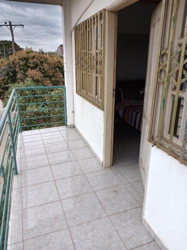 a balcony with a door and a room with a bed at Recidencial nube69 in Santa Cruz de la Sierra