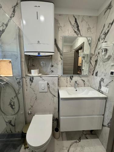 a bathroom with a white sink and a toilet at Apartments Peričić in Podstrana