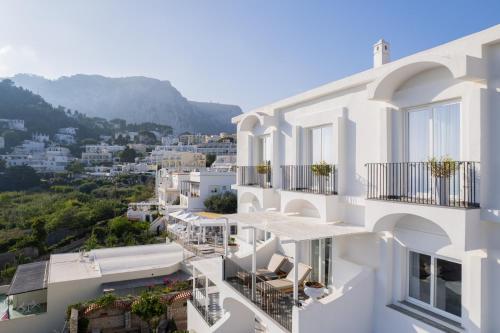 a view of a white building with balconies at Hotel Mamela in Capri
