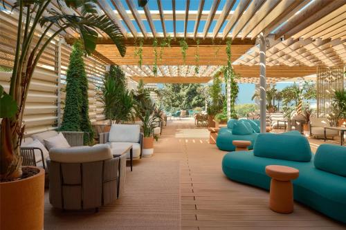 an outdoor patio with blue couches and plants at Radisson Blu Resort & Spa in Split