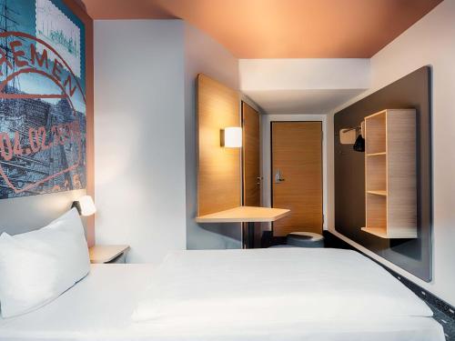 a hotel room with a bed and a desk at B&B Hotel Bremen-City in Bremen