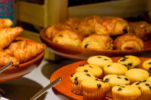 a table with plates of blueberry muffins and other pastries at Radisson Resort Mui Ne in Mui Ne