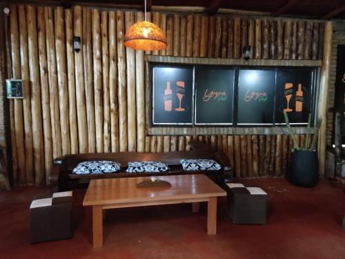 a living room with a couch and a table at YVYRA Hotel & Cabañas in La Porteña