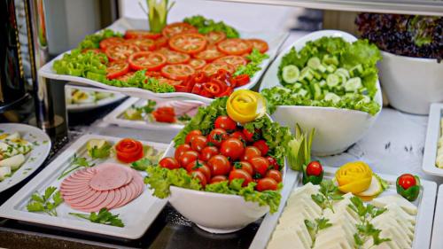 a buffet with tomatoes lettuce and other vegetables in bowls at Kent Hotel in Istanbul