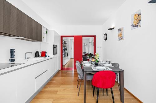a kitchen and dining room with a table and chairs at Luxury Brera apartment - Corso Como 9 in Milan