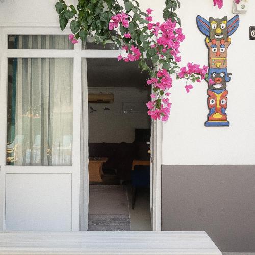 a door to a building with pink flowers on it at Hillside Apart House in Side