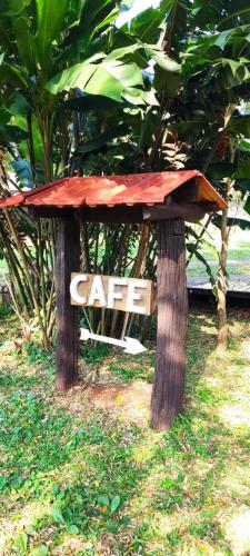 a sign that says care sitting in the grass at YVYRA Hotel & Cabañas in La Porteña