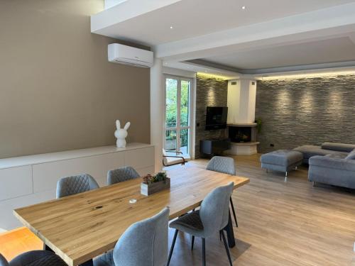 a living room with a wooden table and chairs at Villa Rose in Baveno