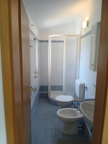 a bathroom with two toilets and a shower at Put Kandelica 86 in Privlaka