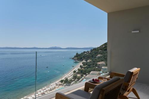 a living room with a view of the ocean at Atlantica Nissaki Beach - Adults Only in Gimari