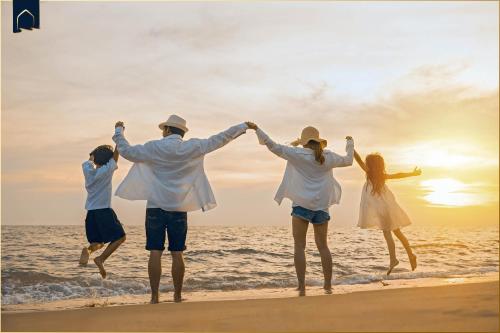 a group of people jumping on the beach at Am Strauchelfeld 5 Whg 7 in Ostseebad Koserow