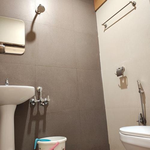 a bathroom with a sink and a toilet at Hotel RK Koramangala in Bangalore