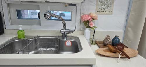 a kitchen sink with a faucet on a counter at Gongrim Stay in Seoul