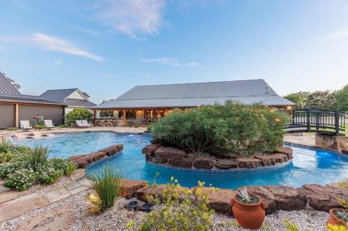a swimming pool in the middle of a yard at Bent Oak Highland Ranch and Concierge Services in Burnet