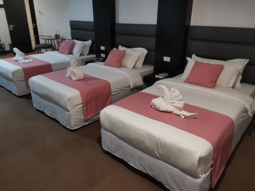 a group of four beds with stuffed animals on them at Palette in Angeles Pampanga near Clark International Airport Formerly Boss Hotel in Angeles