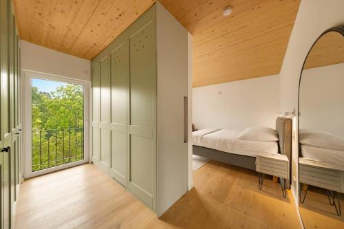 a bedroom with a bed and a window at Forest Retreat- Serene 160m2 with Forest Views in Wermelskirchen