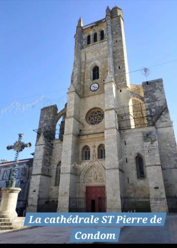 a large stone building with a clock tower at Monette in Condom